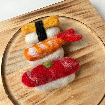 Felt sushi set on a wooden board