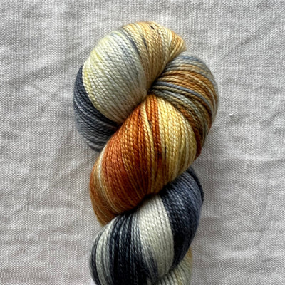 Multicolored skein of yarn on a textured gray background