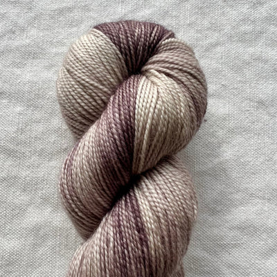 Skein of multicolored yarn on a gray fabric background