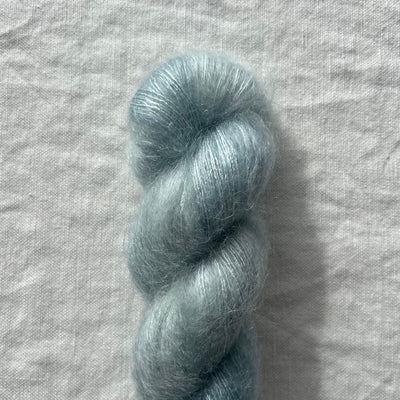 Blue skein of yarn on a textured gray background