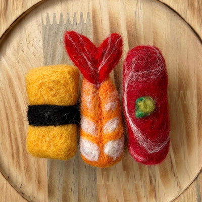 Felted sushi set on a wooden plate