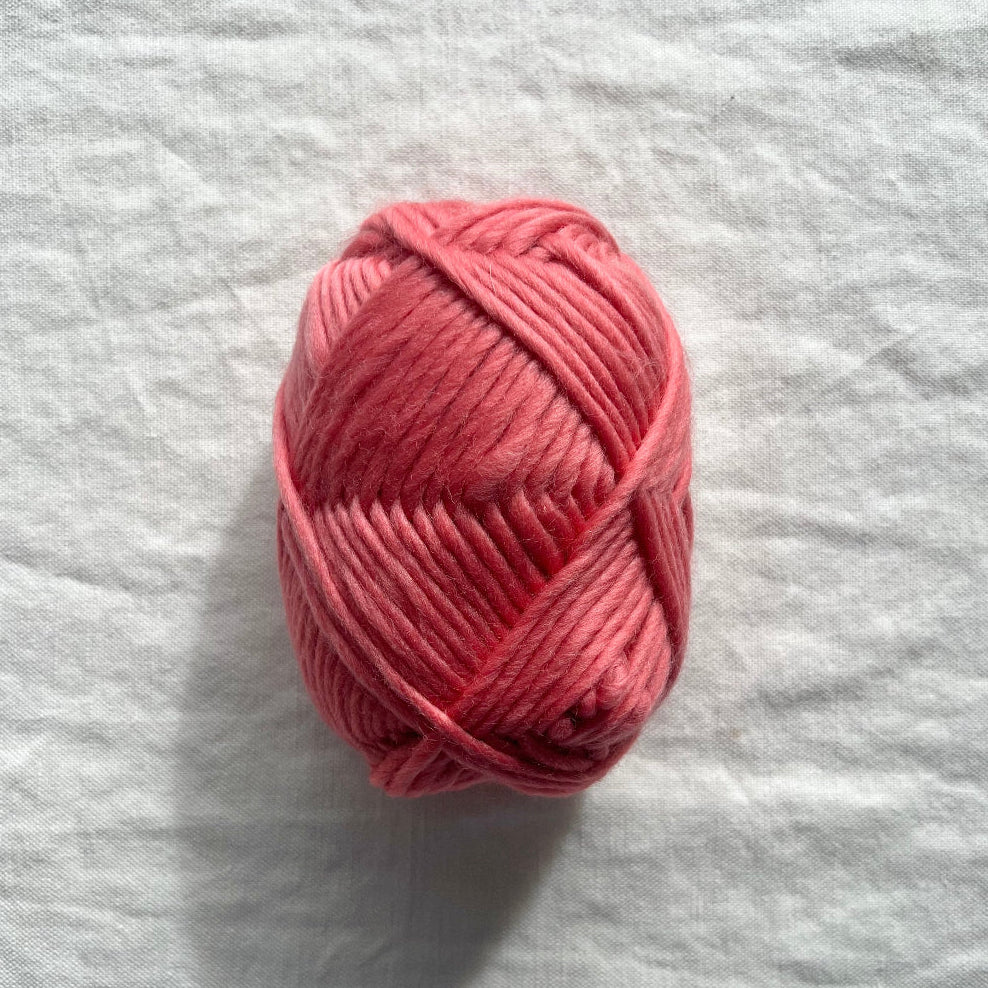 Pink yarn on white background