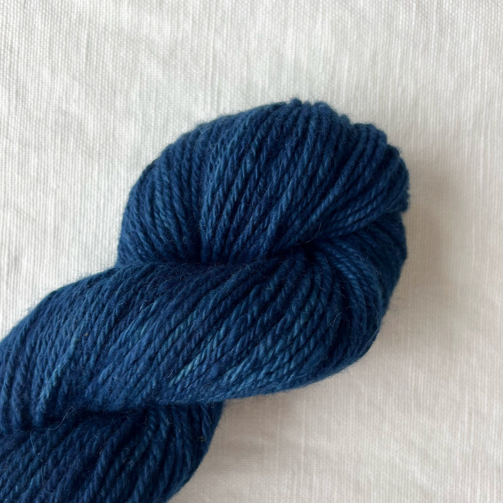 Blue skein of yarn on a light gray background