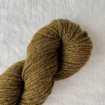 Green skein of yarn on light background