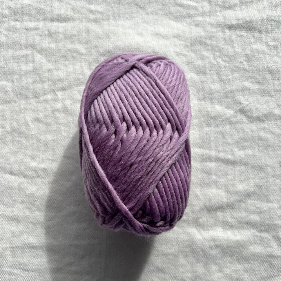 Purple yarn on white background