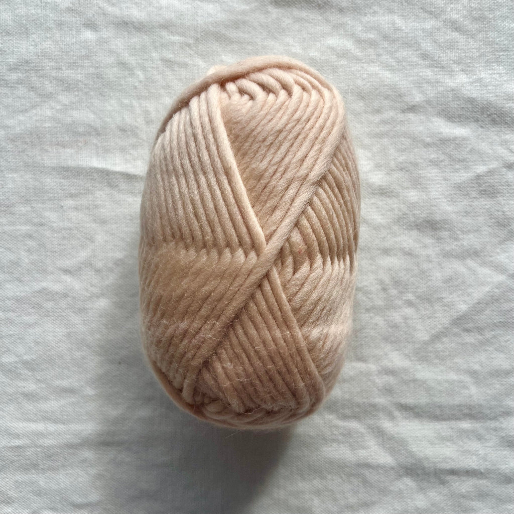 Light pink yarn on white background