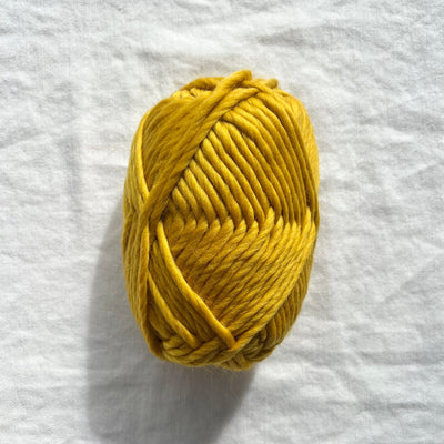 Yellow yarn on white background