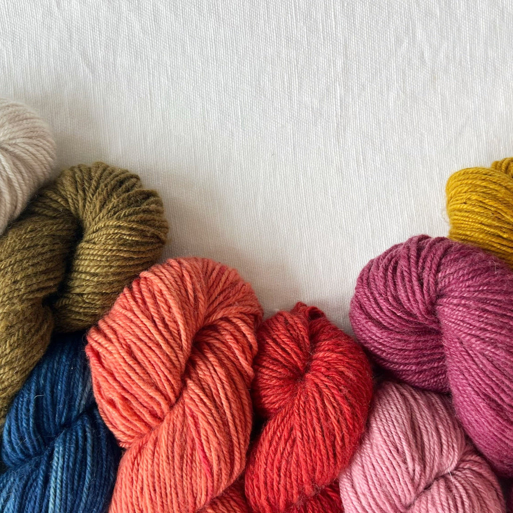 Colorful skeins of yarn on a white background