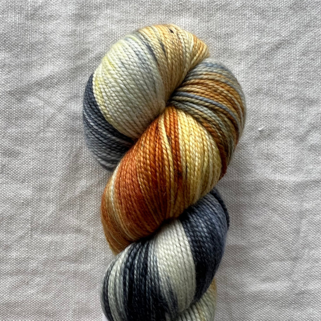 Multicolored skein of yarn on a textured gray background