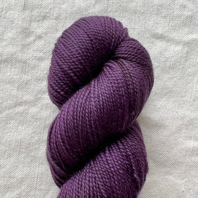 Purple yarn on white background
