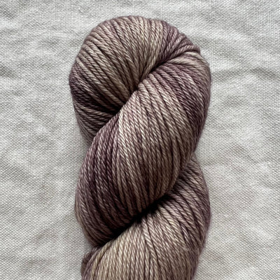 Skein of gray yarn on a light gray fabric background