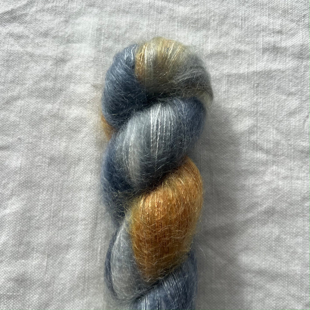 Multicolored yarn skein on a textured gray background