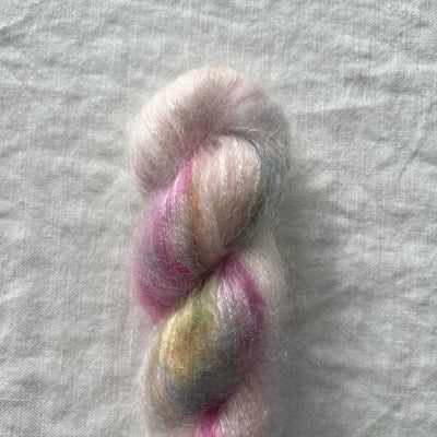 Multicolored yarn skein on a gray fabric background