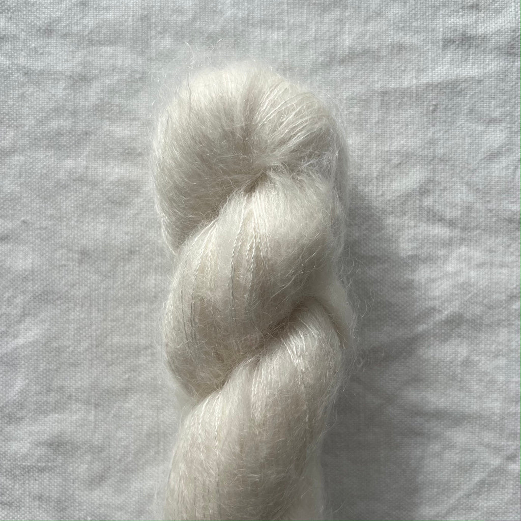 white yarn on a textured gray background