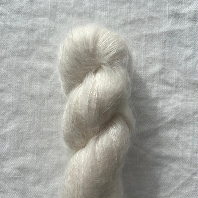 white yarn on a textured gray background
