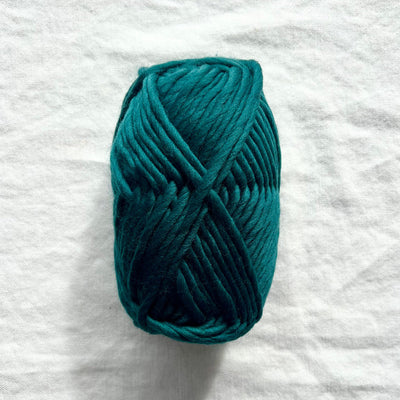 teal yarn on white background