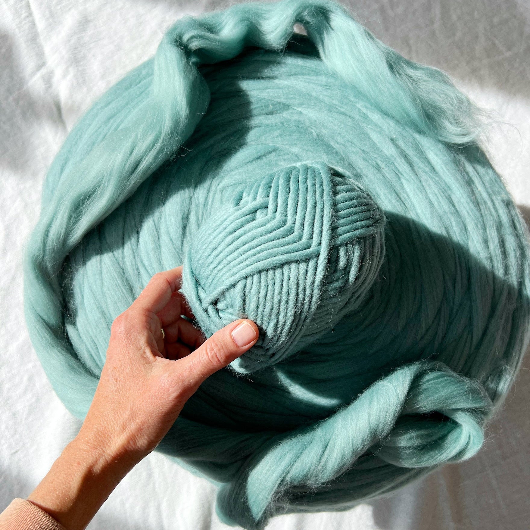 Teal colored Twin Merino yarn and roving