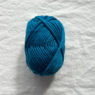 Teal yarn on white background