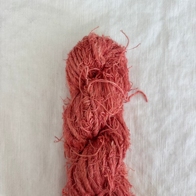 Ball of red yarn on a light gray background