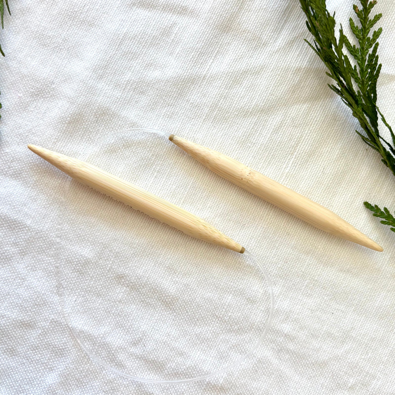 circular knitting needles against fabric background