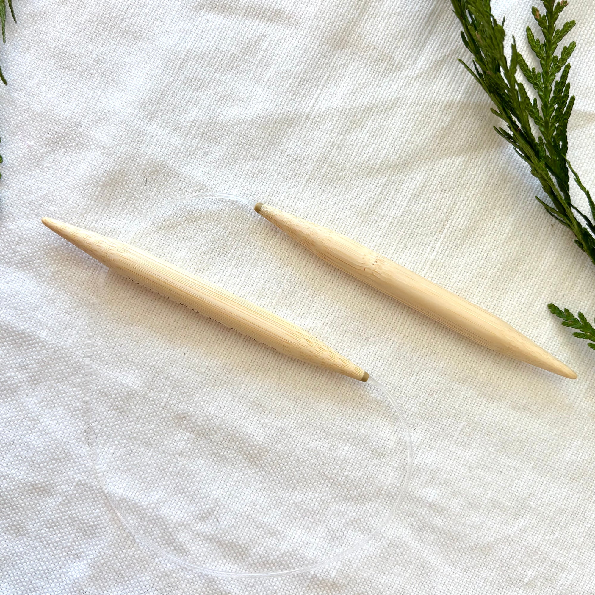 circular knitting needles against fabric background