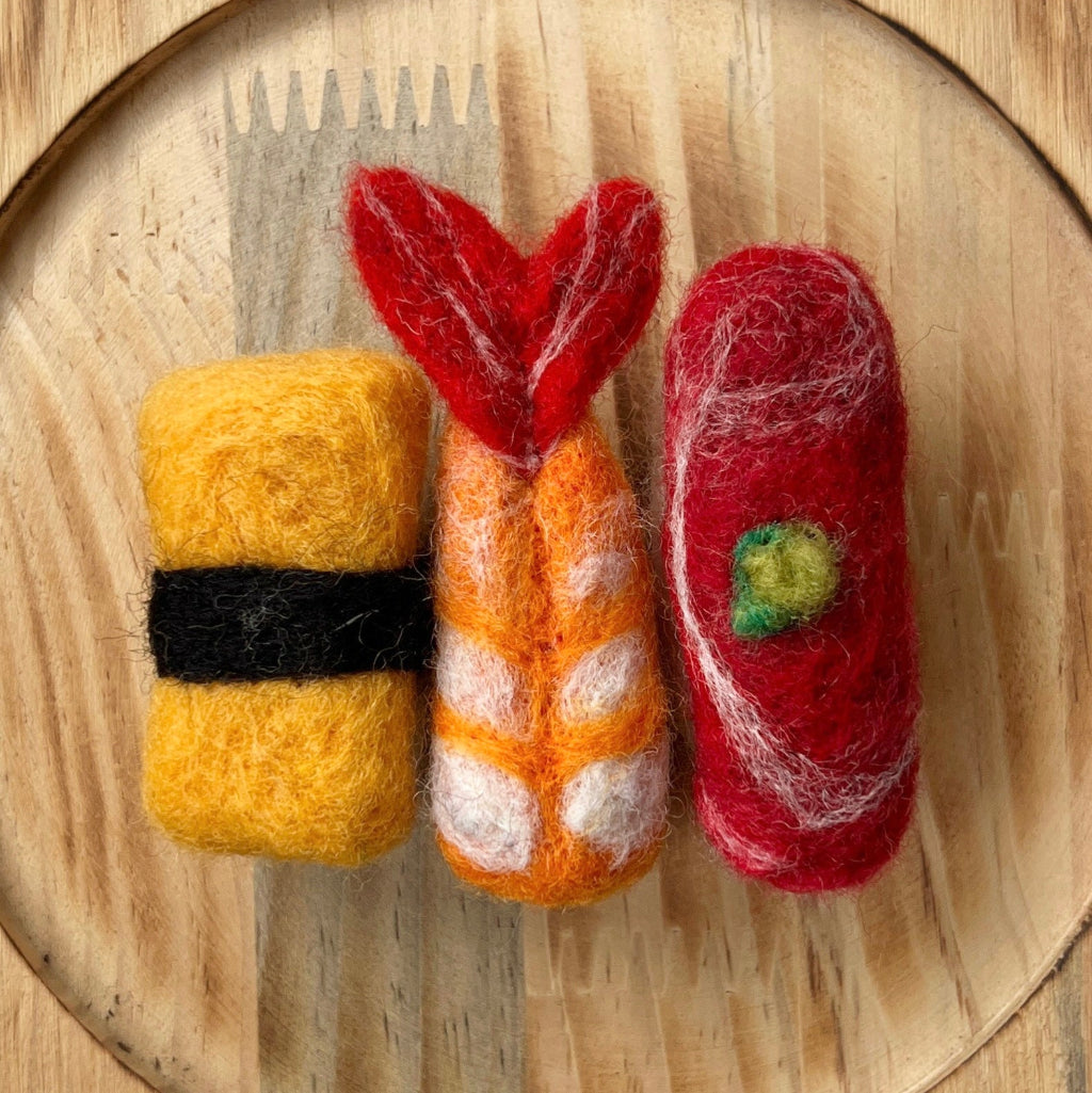 Felted sushi set on a wooden plate
